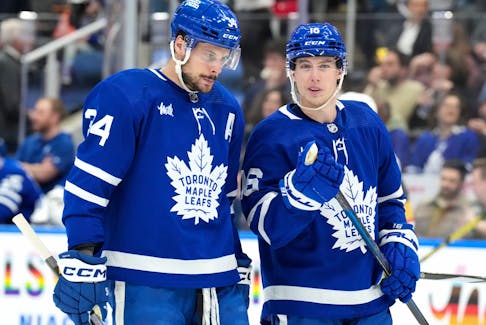 Toronto Maple Leafs' Auston Matthews (left) talks with Mitch Marner.