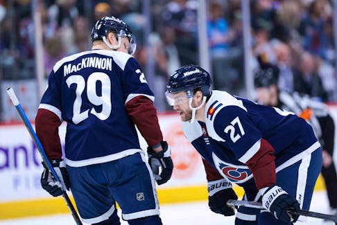 Colorado Avalanche forwards Jonathan Drouin, right, and Nathan MacKinnon talk before a face-off during an NHL game against the Nashville Predators at Ball Arena in Denver last week. - Andrew Wevers-USA TODAY Sports