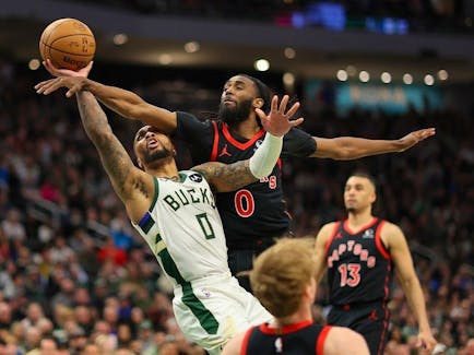 Damian Lillard #0 of the Milwaukee Bucks is fouled by Gradey Dick #1 of the Toronto Raptors during the second half of a game at Fiserv Forum on April 05, 2024 in Milwaukee, Wisconsin.  