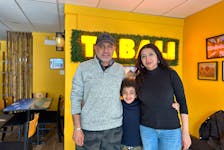 Rania Farouk Ismail, right, joins her husband, Walid Elbadri, and their eight-year-old son, Jawad Elbadri, inside their family restaurant, Tabali Grillz, in Charlottetown. The establishment offers a variety of authentic Egyptian and Middle Eastern dishes. Thinh Nguyen • The Guardian