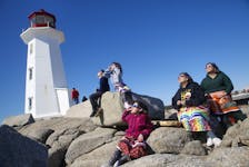 Monique Fong Howe and Yvette Arcand watch the solar eclipse with sone of their grandchildren at Peggy’s Cove, NS April 8, 2024.

TIM KROCHAK PHOTO