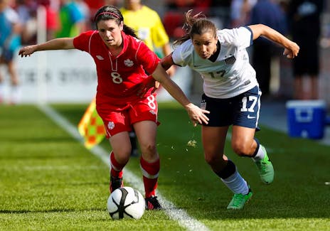 Diana Matheson, left, of Canada battles for the ball with Tobin Heath of the U.S. during the first half of their friendly women's soccer match in Toronto, June 2, 2013. - REUTERS/Mark Blinch