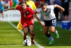Diana Matheson, left, of Canada battles for the ball with Tobin Heath of the U.S. during the first half of their friendly women's soccer match in Toronto, June 2, 2013. - REUTERS/Mark Blinch