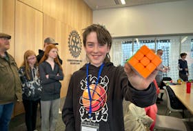 11-year-old Gavin Carey-Sullivan holds up his Rubik’s cube at P.E.I.'s first-ever speedcubing competition on April 7, where he reached the finals. Thinh Nguyen • The Guardian