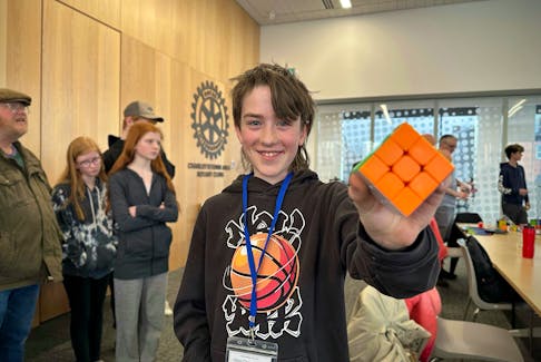 11-year-old Gavin Carey-Sullivan holds up his Rubik’s cube at P.E.I.'s first-ever speedcubing competition on April 7, where he reached the finals. Thinh Nguyen • The Guardian