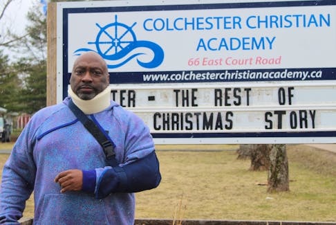 Wallace Fowler stands in front of Colchester Christian Academy. Fowler says he was injured in an altercation with police.