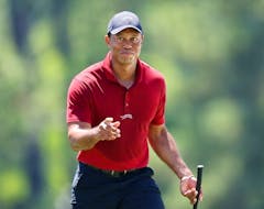 Tiger Woods of the United States acknowledges the crowd while walking to the 18th green during the final round of the 2024 Masters Tournament at Augusta National Golf Club on Sunday, April 14, 2024 in Augusta, Georgia.