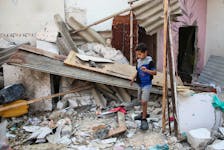 A Palestinian boy inspects the site of an Israeli strike on a house, amid the ongoing conflict between Israel and the Palestinian Islamist group Hamas, in Rafah, in the southern Gaza Strip, May 1, 2024.