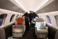 A VistaJet cabin hostess walks through the interior of a new Bombardier Global 7500 business jet as the company celebrates its 10th delivery of this aircraft to VistaJet in Montreal, Quebec, Canada March 29, 2022. 