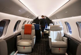 A VistaJet cabin hostess walks through the interior of a new Bombardier Global 7500 business jet as the company celebrates its 10th delivery of this aircraft to VistaJet in Montreal, Quebec, Canada March 29, 2022. 