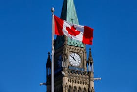 A Canadian flag flies in front of the Peace Tower on Parliament Hill in Ottawa, Ontario, Canada, March 22, 2017.