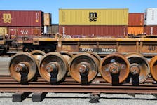 Train wheels are stored next to shipping containers on rail cars at Roberts Bank Superport in Delta, British Columbia, Canada July 2, 2023.