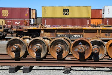 Train wheels are stored next to shipping containers on rail cars at Roberts Bank Superport in Delta, British Columbia, Canada July 2, 2023.