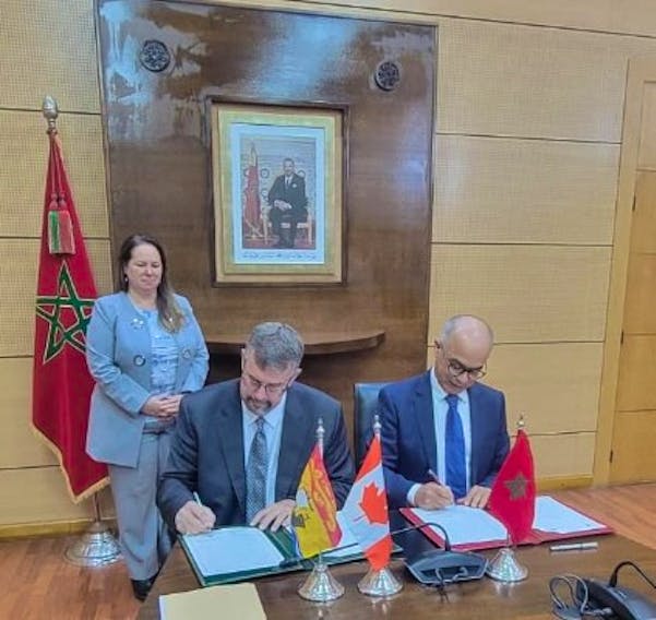 The provincial government has signed a bilateral education agreement with Morocco. Seated, from left: Education Minister Bill Hogan and Chakib Benmoussa, Morocco’s minister of national education, early childhood, and sport. Standing: Isabelle Valois, Canadian ambassador to Morocco.