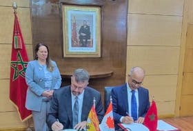 The provincial government has signed a bilateral education agreement with Morocco. Seated, from left: Education Minister Bill Hogan and Chakib Benmoussa, Morocco’s minister of national education, early childhood, and sport. Standing: Isabelle Valois, Canadian ambassador to Morocco.