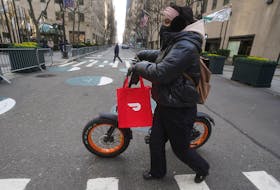 A DoorDash delivery person is pictured on the day they hold their IPO in the Manhattan borough of New York City, New York, U.S., December 9, 2020.