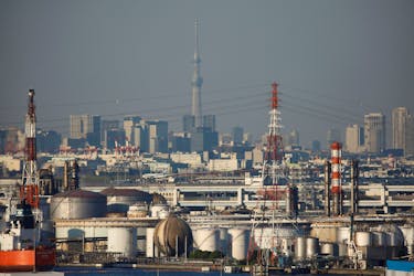 Chimneys of an industrial complex and Tokyo's skyline are seen from an observatory deck at an industrial port in Kawasaki, Japan, October 24, 2016.