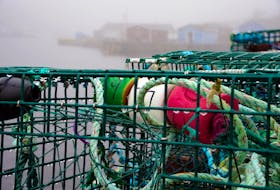 Wet wharf  
   Lobster pots sit on the wharf in the fog-shrouded town of Petty Harbour Monday April 29. Keith Gosse • The Telegram