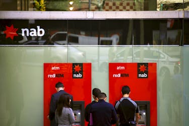 Customers withdraw money from National Australia Bank (NAB) Automatic Teller Machines (ATMs) in central Sydney, Australia, July 24, 2015.