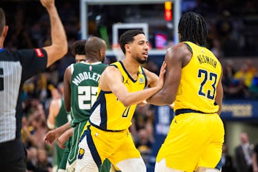 Apr 28, 2024; Indianapolis, Indiana, USA; Indiana Pacers guard Tyrese Haliburton (0) holds back forward Aaron Nesmith (23) after a hard foul during game four of the first round for the 2024 NBA playoffs against the Milwaukee Bucks at Gainbridge Fieldhouse. Mandatory Credit: Trevor Ruszkowski-USA TODAY Sports