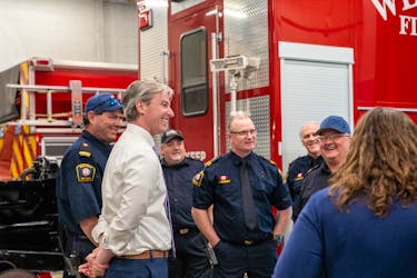 Premier Tim Houston visits with Westville firefighters.
