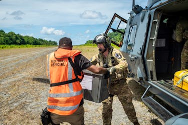 Members of the New Zealand Defence Force (NZDF) Joint Task Force assist in delivering ballot boxes by NH90 helicopter to remote areas of the Solomon Islands, April 17, 2024. New Zealand Defence Force/Handout via REUTERS