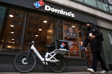 A person walks past a Domino's pizza restuarant in London, Britain, March 4, 2023.