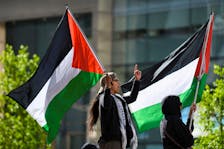 Protesters wave Palestinian flags as students and workers hold a pro-Palestinian rally outside MIT's Stata Center, demanding MIT divest from Israel, among other demands, in Cambridge, Massachusetts, U.S. May 9, 2024.