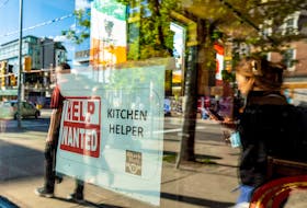 A help wanted sign hangs in a bar window along Queen Street West in Toronto Ontario, Canada June 10, 2022.