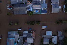 A drone view shows the Brazilian flag painted on a house as streets are flooded in Eldorado do Sul, Rio Grande do Sul state, Brazil, May 9, 2024.