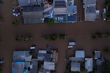 A drone view shows the Brazilian flag painted on a house as streets are flooded in Eldorado do Sul, Rio Grande do Sul state, Brazil, May 9, 2024.