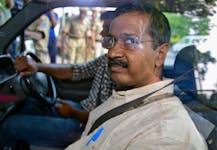Arvind Kejriwal, the head of the Aam Aadmi (Common Man) Party (AAP), which briefly controlled the state government in Delhi, looks out from inside his car as he arrives at a court in New Delhi May 21, 2014. 
