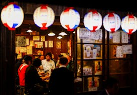 People enjoy drinks and food at an izakaya pub restaurant at the Ameyoko shopping district, in Tokyo, Japan February 15, 2024.