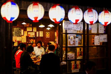 People enjoy drinks and food at an izakaya pub restaurant at the Ameyoko shopping district, in Tokyo, Japan February 15, 2024.