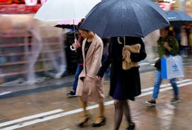 Shoppers walk through the rain in an Osaka shopping district in western Japan October 22, 2017.