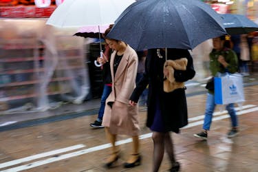Shoppers walk through the rain in an Osaka shopping district in western Japan October 22, 2017.