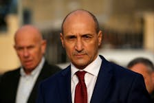 Maltese Health Minister Chris Fearne looks on as he talks to the media after a fire destroyed part of a reception centre for migrants in Marsa, Malta January 8, 2020.