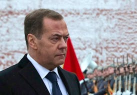 Russia's Deputy head of the Security Council Dmitry Medvedev takes part in a wreath laying ceremony marking Defender of the Fatherland Day at the Tomb of the Unknown Soldier by the Kremlin Wall in Moscow, Russia, February 23, 2024. Sputnik/Yekaterina Shtukina/Pool via