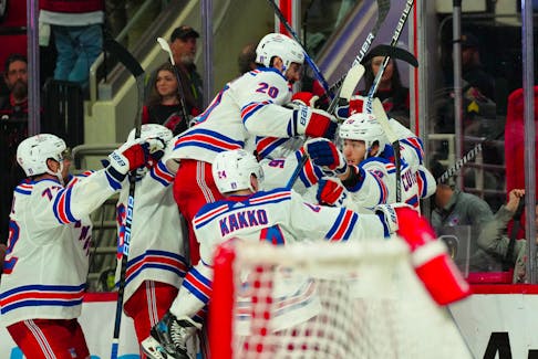 May 9, 2024; Raleigh, North Carolina, USA; New York Rangers left wing Artemi Panarin (10) is congratulated by his teammates after his goal in the first overtime against the Carolina Hurricanes in game three of the second round of the 2024 Stanley Cup Playoffs at PNC Arena. Mandatory Credit: James Guillory-USA TODAY Sports