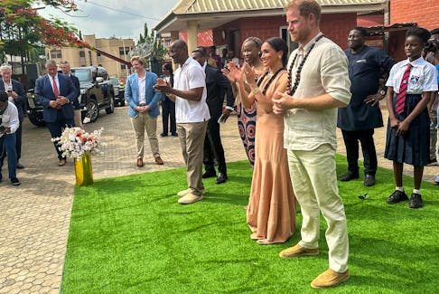 Britain's Prince Harry, Duke of Sussex and his wife Meghan, Duchess of Sussex, arrive to meet  students at the Lightway Academy up on their arrival in Abuja, Nigeria, May 10, 2024.