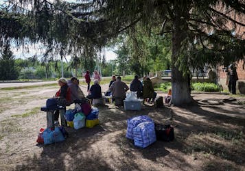 Residents from Vovchansk and nearby villages wait for buses amid an evacuation to Kharkiv due to Russian shelling, amid Russia's attack on Ukraine, at an undisclosed location near the town of Vovchansk in Kharkiv region, Ukraine May 10, 2024.