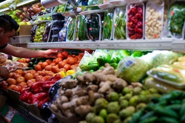 A person arranges groceries in El Progreso Market in the Mount Pleasant neighborhood of Washington, D.C., U.S., August 19, 2022.