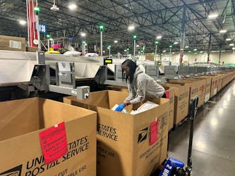 A employee works as the largest United States Postal Service (USPS) facility gears up for the busiest shipping time of the year, in Los Angeles, California, U.S. November 30, 2023.