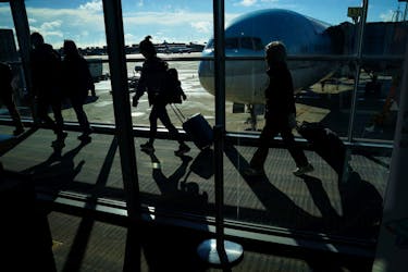 Passengers make their way through the terminal as they travel ahead of the Thanksgiving holiday at Washington Dulles International Airport in Dulles, Virginia, U.S., November 22, 2023.
