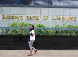 A woman walks past the Reserve Bank of Zimbabwe building in Harare, Zimbabwe March 1, 2024.