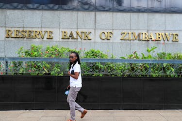A woman walks past the Reserve Bank of Zimbabwe building in Harare, Zimbabwe March 1, 2024.