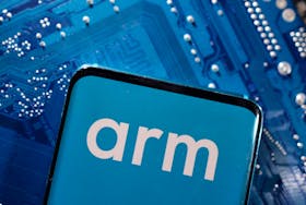 A smartphone with a displayed Arm Ltd logo is placed on a computer motherboard in this illustration taken March 6, 2023.