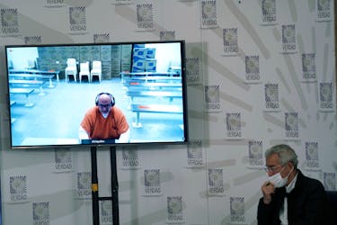 Former paramilitary leader Salvatore Mancuso gives testimony though live video screen to the country's truth commission as Francisco de Roux, President of the Truth Commission looks on in Bogota, Colombia, August 4, 2021.