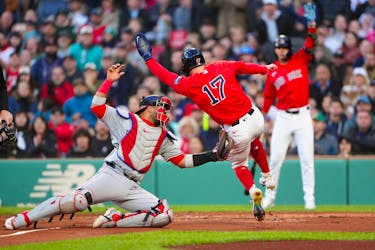 May 10, 2024; Boston, Massachusetts, USA; Boston Red Sox right fielder Tyler O'Neill (17) is tagged out by Washington Nationals catcher Keibert Ruiz (20) trying to score on Boston Red Sox catcher Connor Wong (not pictured) single during the first inning at Fenway Park. Mandatory Credit: Gregory Fisher-USA TODAY Sports
