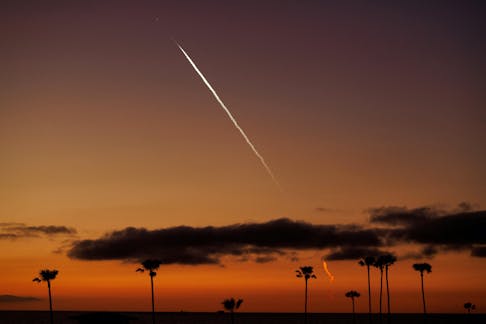 An evening launch of a SpaceX Falcon 9 rocket carrying 22 Starlink satellites to low-Earth orbit from Space Launch Complex 4 East (SLC-4E) at Vandenberg Space Force Base is seen over the Pacific Ocean from Encinitas, California, U.S., April 1, 2024. 